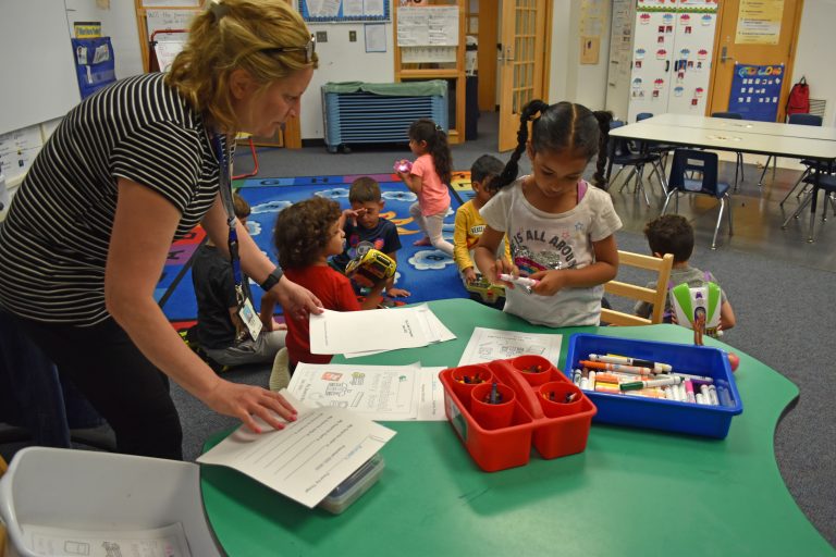 A teacher helps a student in a GSRP classroom in the spring 2022.